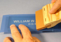 Run a squeegee over the stencil.